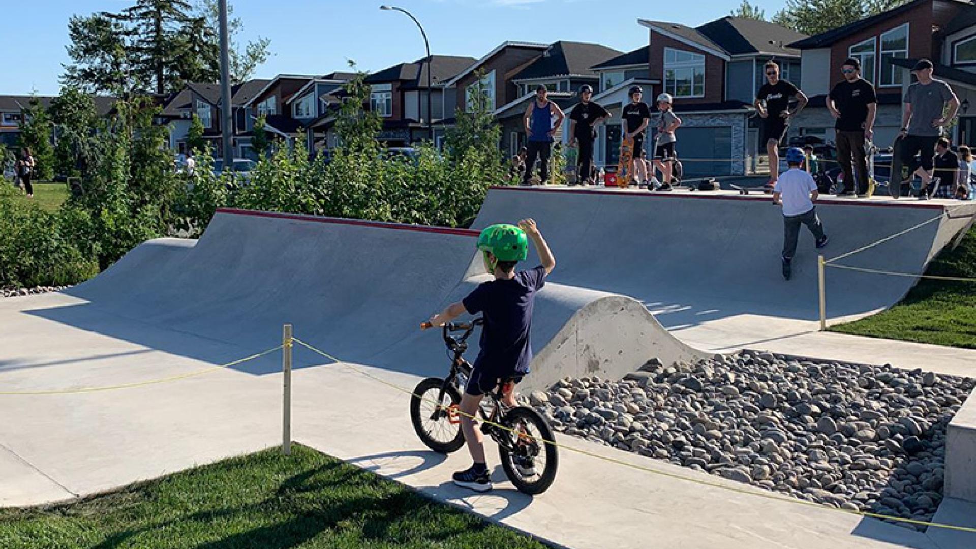 Kids waving to each other from across the Firefighters Park ramp