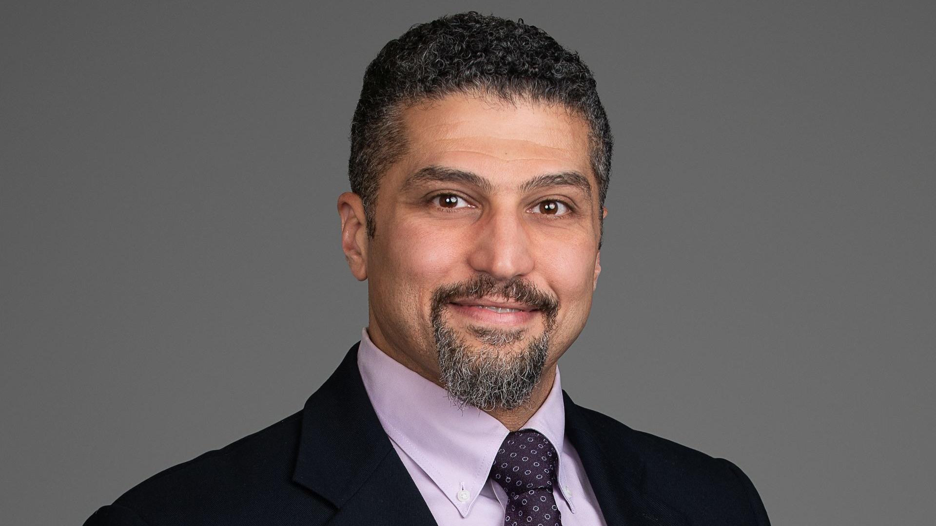 Headshot of smiling councillor Ahmed Yousef