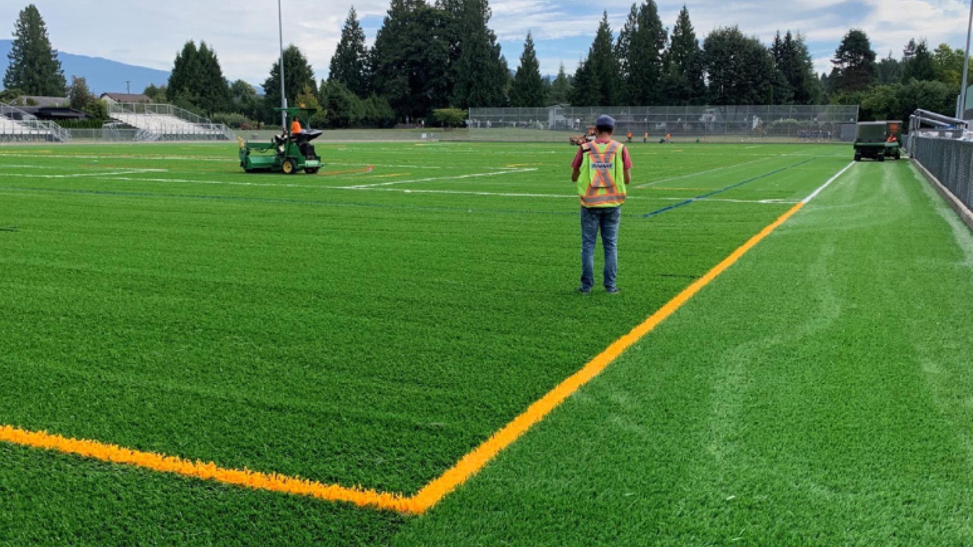 People standing on synthetic turf in Westview Sports Field