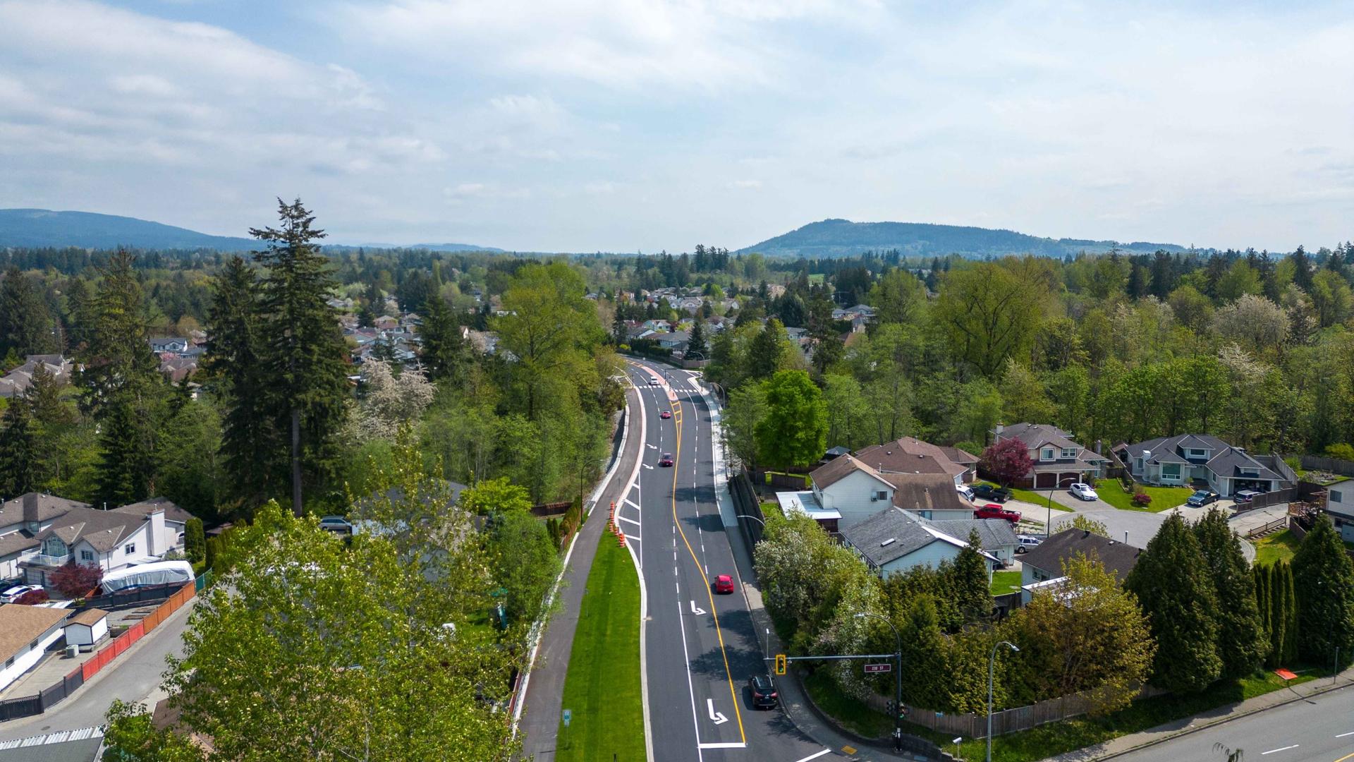 An aerial view looking down Abernethy Way. The road appears to be freshly paved.