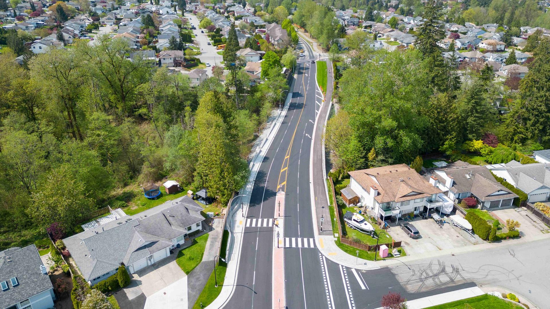 An aerial view looking down the newly paved section of Abernethy Way.