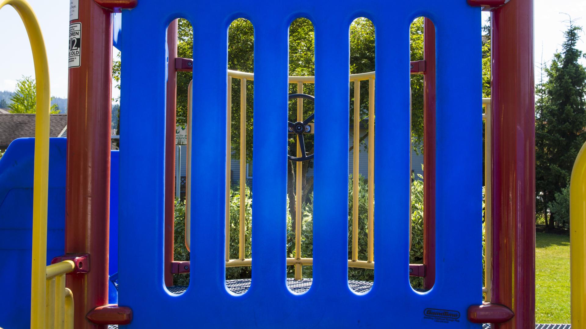The blue plastic side wall of a playground.
