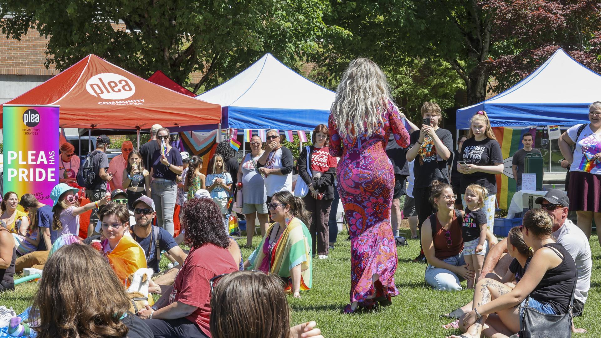 Drag queen walking through a crowd while they admire her performance andskill