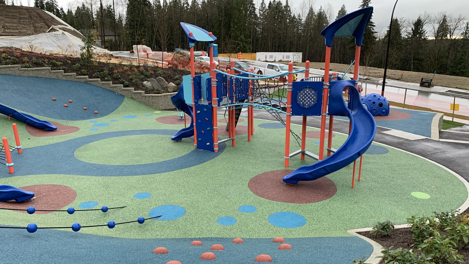 Colourful playground with slides and suspension bridge