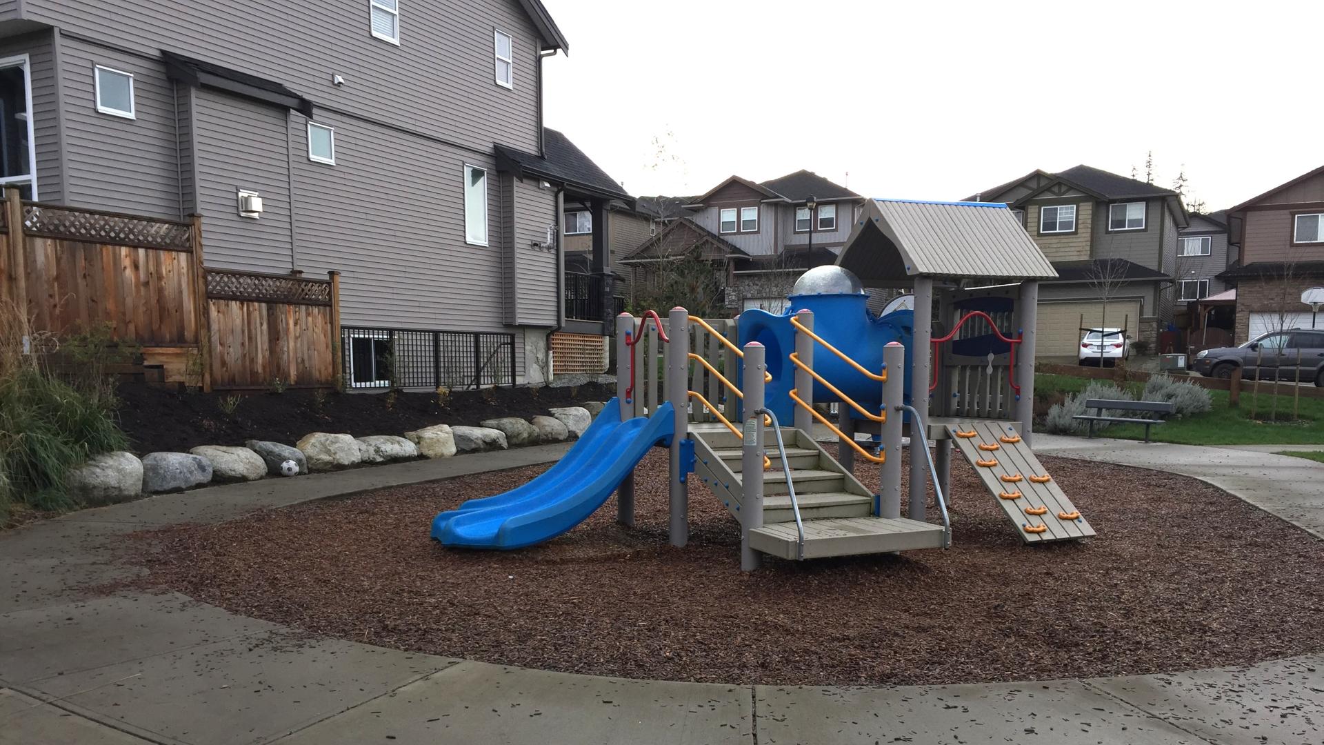 Toddler playground with slide on wood chip surfacing