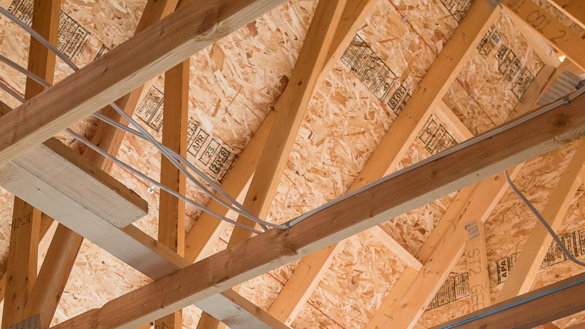 Exposed construction beams form a roof.