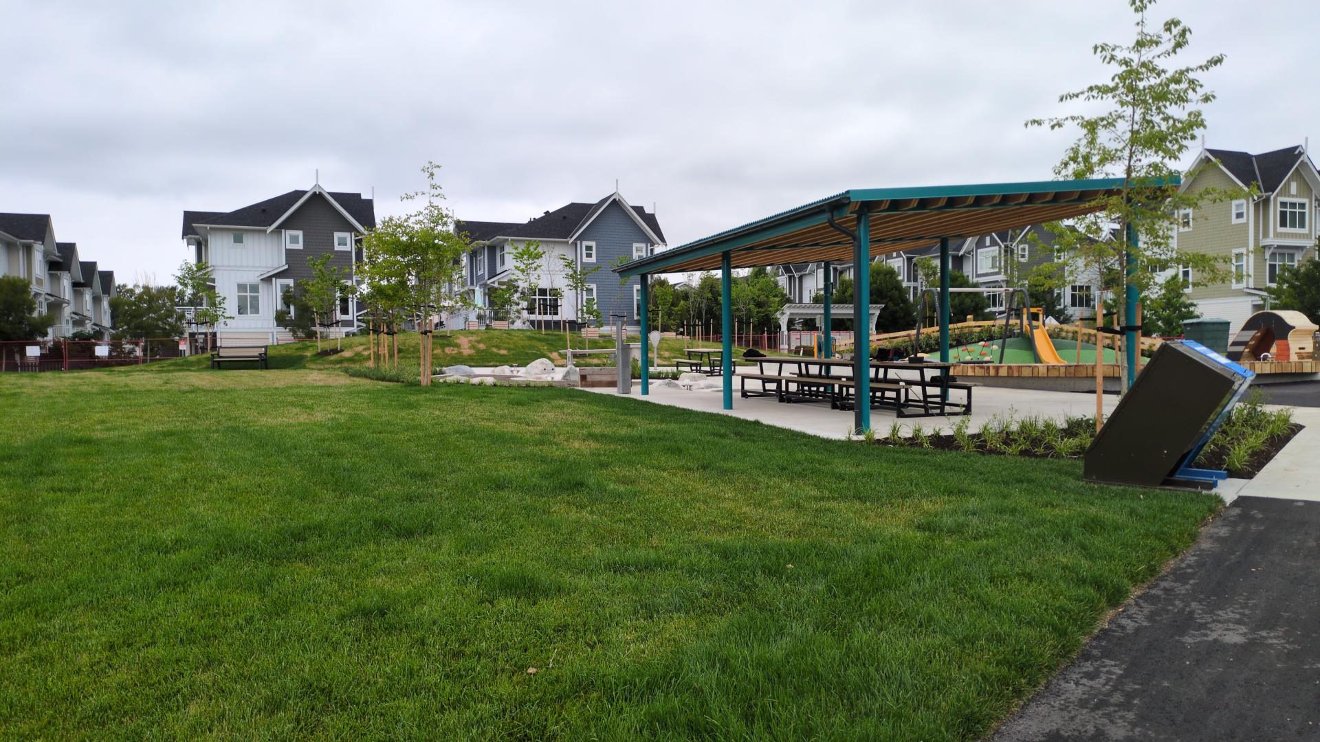 An open lawn area near a picnic shelter