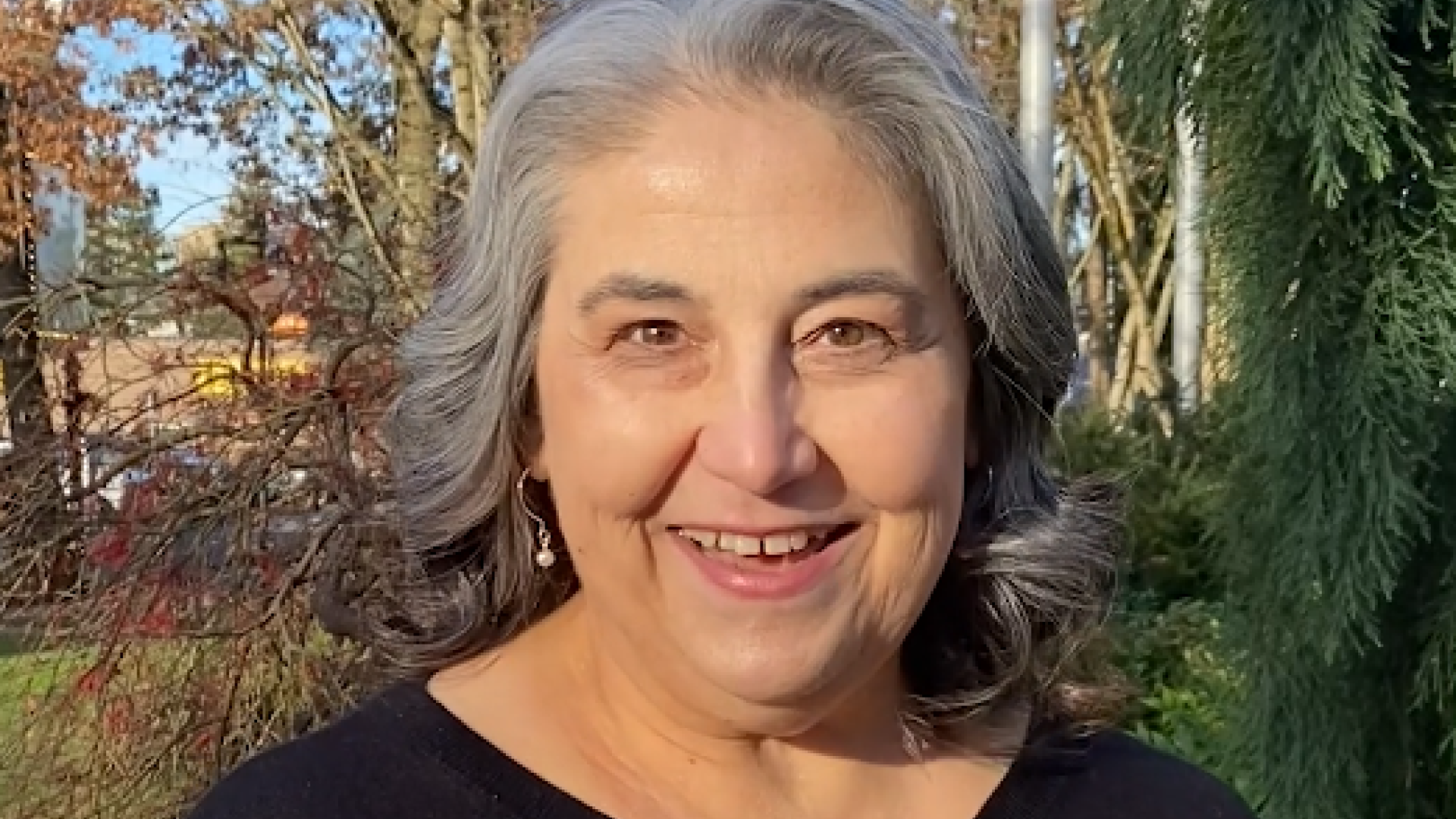 A woman smiles as she lets people know that "We're kicking off our Budget Talks video series,"