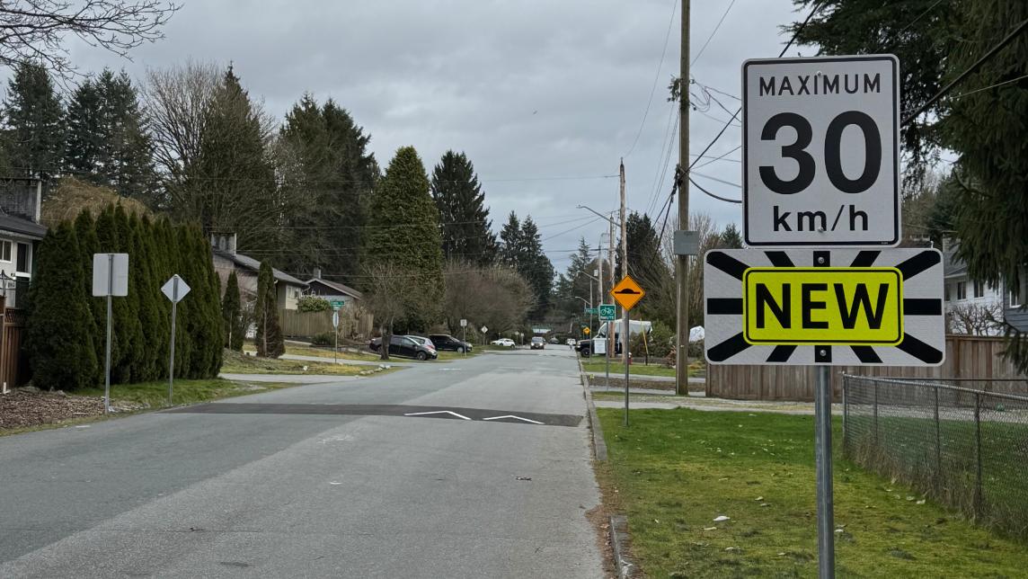 View of the bikeway showing a speed hump and new speed limit sign