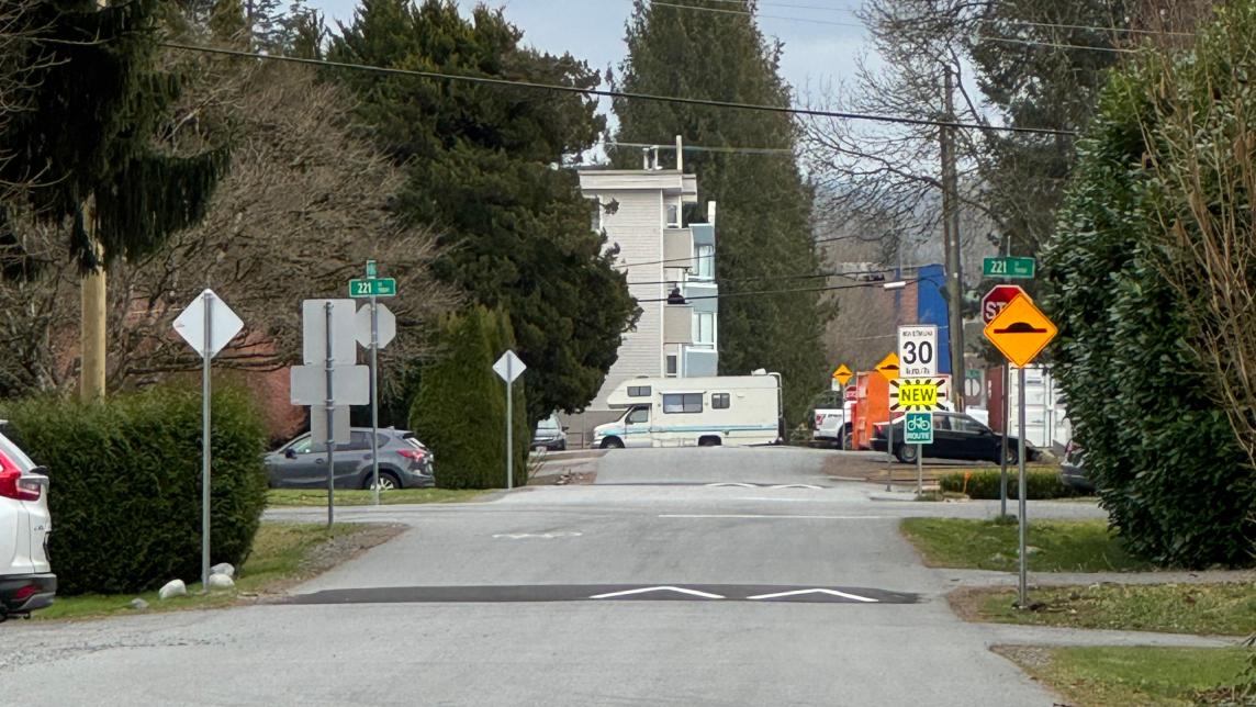 View of the bikeway showing a speed hump and accompanying sign