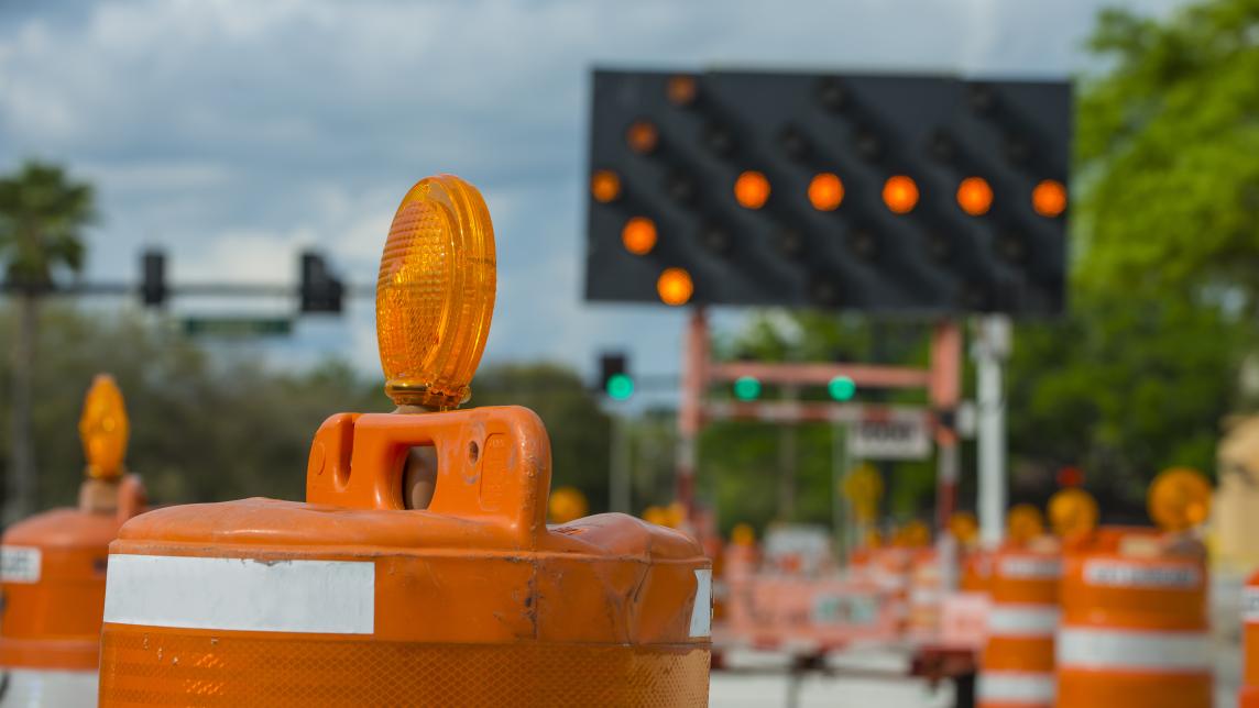 Traffic pylons and an arrow sign in a construction zone