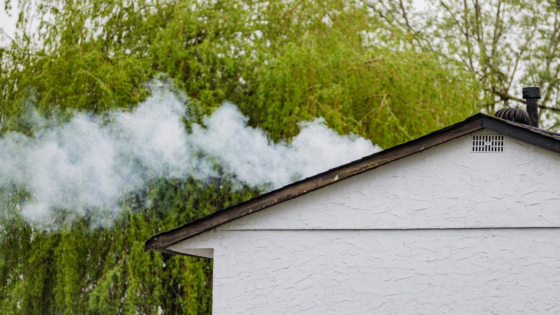 Fog emerges from a sanitary vent on the roof of a house
