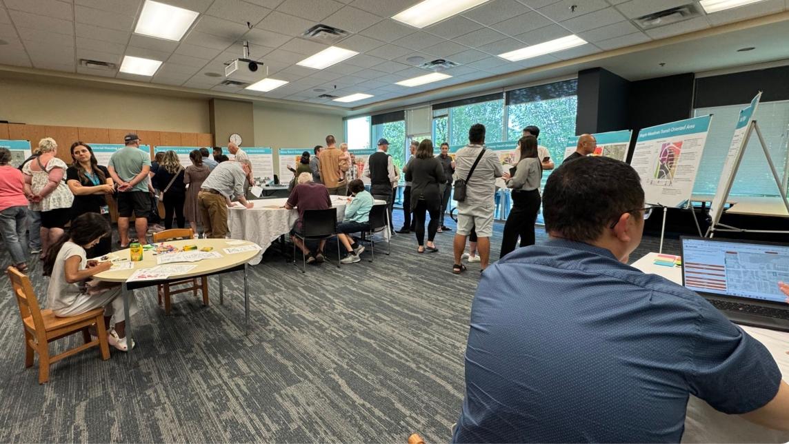 An City open house event at the Maple Ridge Library, filled with people of all ages and walks of life.
