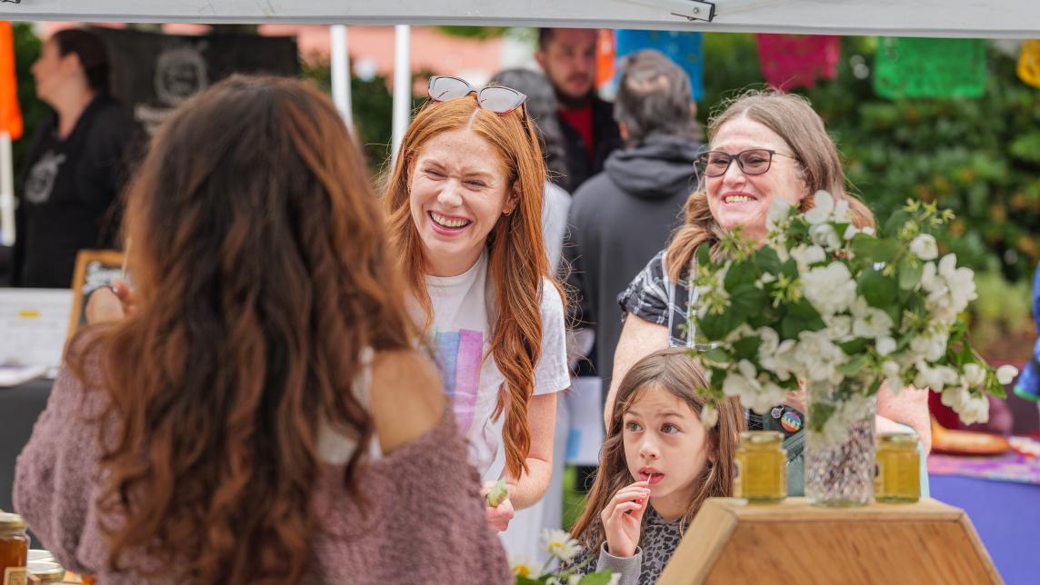 Women and girl smiling with flowers