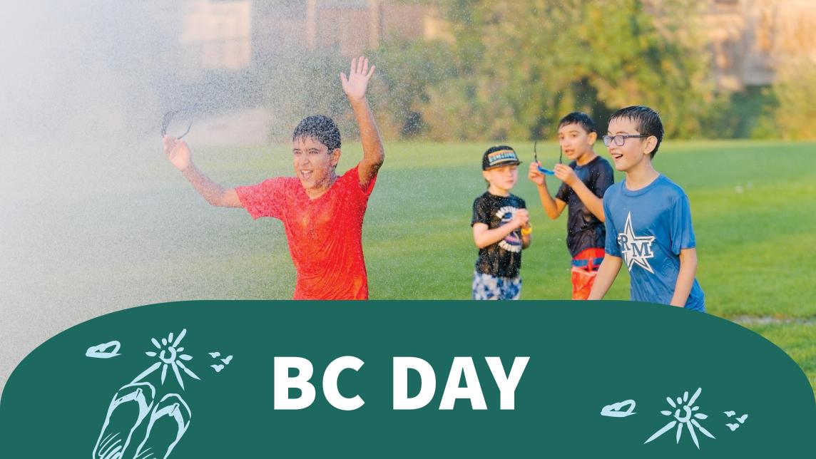 Boys running into a sprinkler