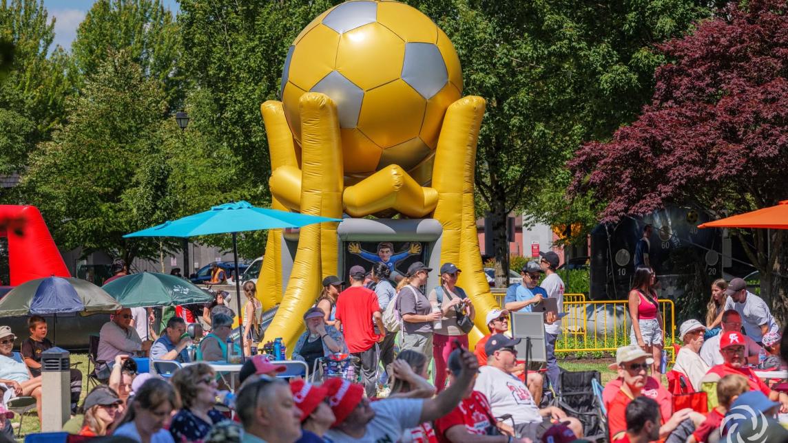 Outdoor Viewing Party crowds of people with gold giant soccer ball