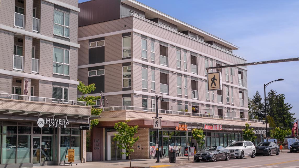 A mixed-use apartment building with residences upstairs, and commercial ventures on ground level.