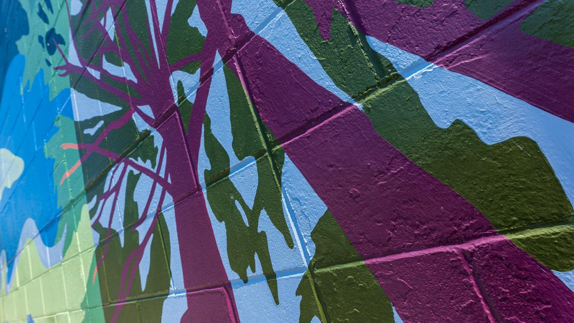 A close-up of the painted pine trees on the mural.