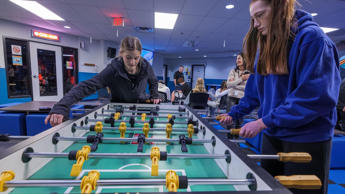 Two grade nine students play foosball in the Greg Moore Youth Centre.