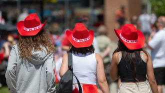 three girls wearing canada day cowboy hats 