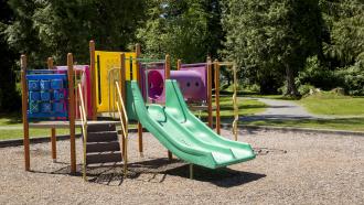 playground structure with plastic slide and climbing features