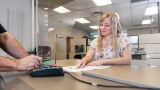 City of Maple Ridge employee helping a customer at the payment counter