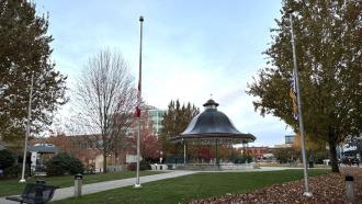 The three flags in front of the Bandstand at Memorial Peace Park hang at half-mast.