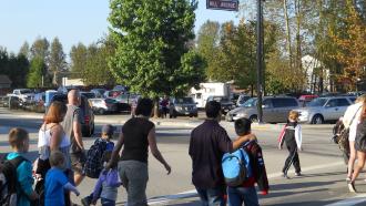 parents and children crossing in a crosswalk at Hill Ave