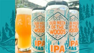 Three tall cans of Our Neck of the Woods collaboration IPA Beer showcase a vivid white background and teal artwork with orange lettering.