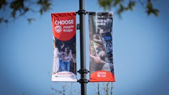 Two of the 2025 Choose Maple Ridge street banners, showcasing local shopping opportunities.