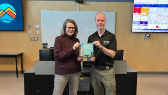 Maple Ridge being presented with certificate from Royal Roads in a classroom setting