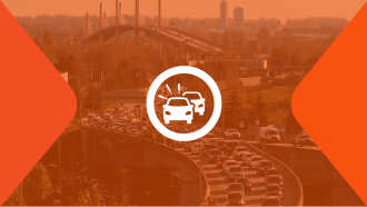 A white icon of two cars bumper to bumper sits on top of an orange-tinged photo of the Golden Ears Bridge and Golden Ears Way leading into Maple Ridge.