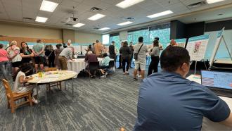 An City open house event at the Maple Ridge Library, filled with people of all ages and walks of life.