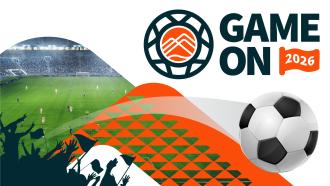 Game On 2026. A soccer ball flies off a field and over the heads of the silhouetted crowd.