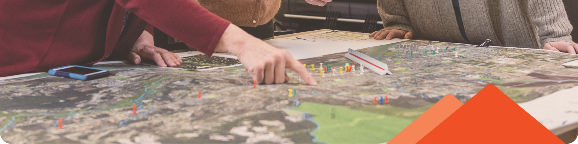 woman's hand pointing something on a map