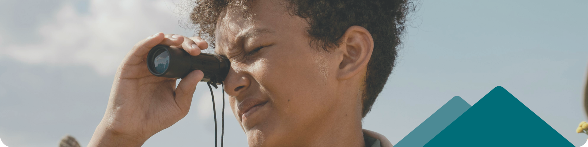 Young Boy Searching Through a Binocular 