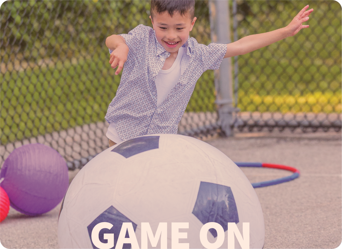 Little Boy Playing with a Large Soccer Ball