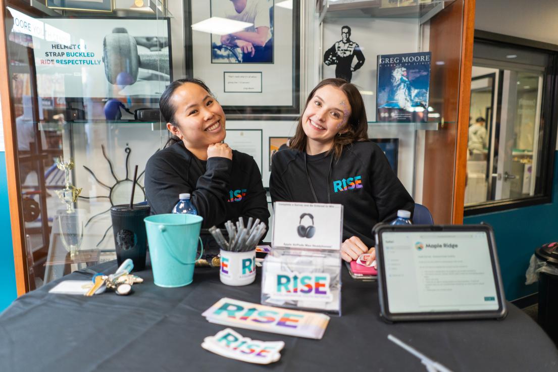 A pair of women welcome guests to the RISE event in the Greg Moore Youth Centre.