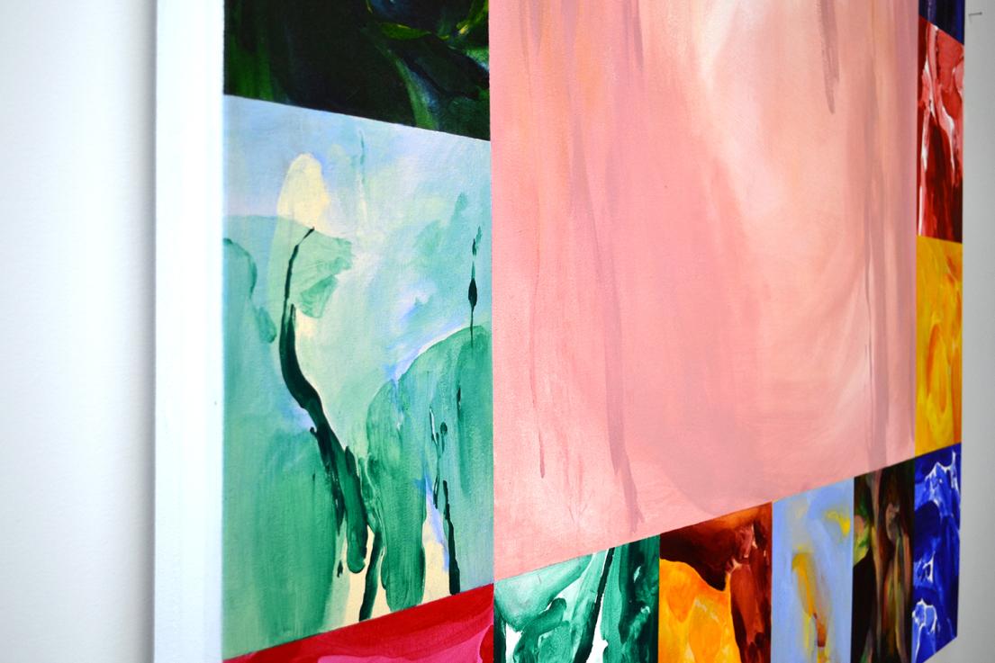 An angled view of a painted collage showing abstract art in vibrant colours.