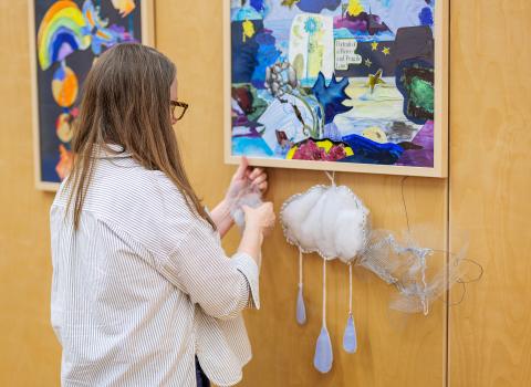 Colleen Brown puts on the finishing touches to River Weather Variable, her art installation at the Albion Community Centre.