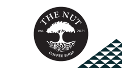 The Nut coffee shop's logo next to a soccer-ball patterned mountain.