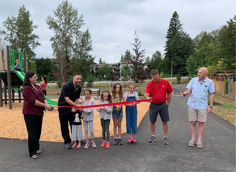 People outside of park cutting ribbon