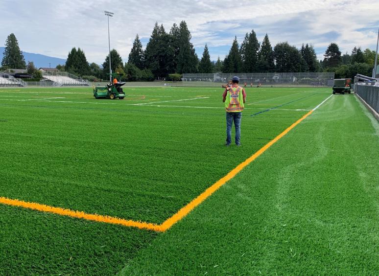 People standing on synthetic turf in Westview Sports Field