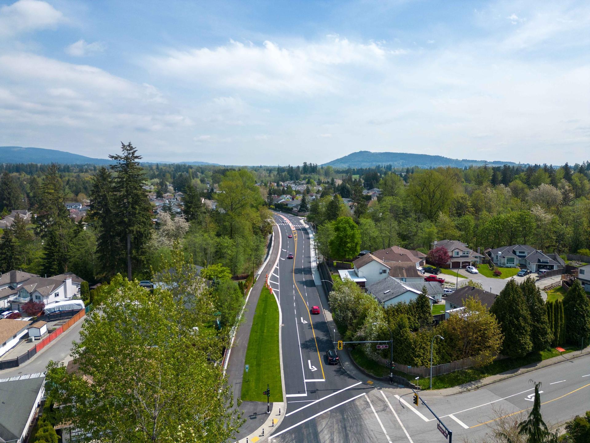 An aerial view looking down Abernethy Way. The road appears to be freshly paved.