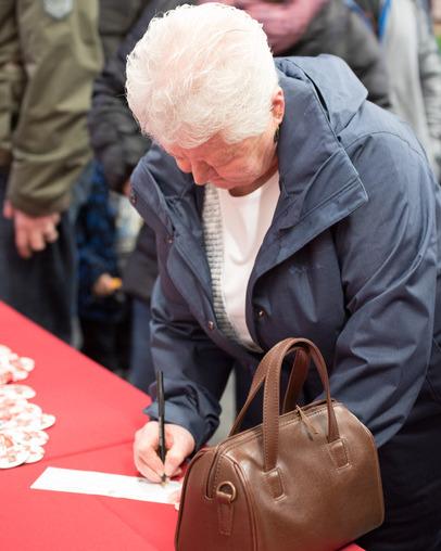 Person filling in a contest entry form at a vendor's exhibit booth