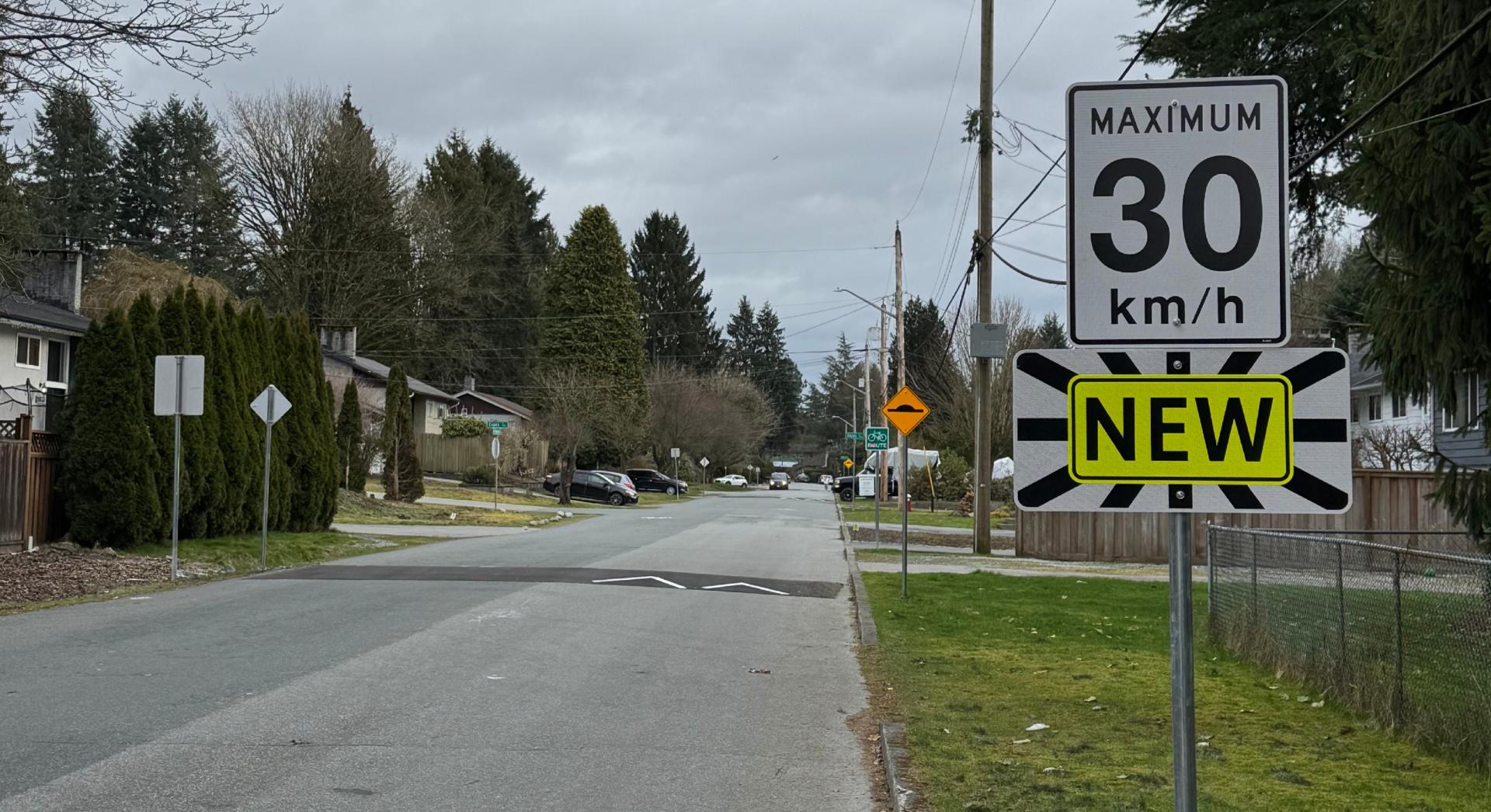 View of the bikeway showing a speed hump and new speed limit sign