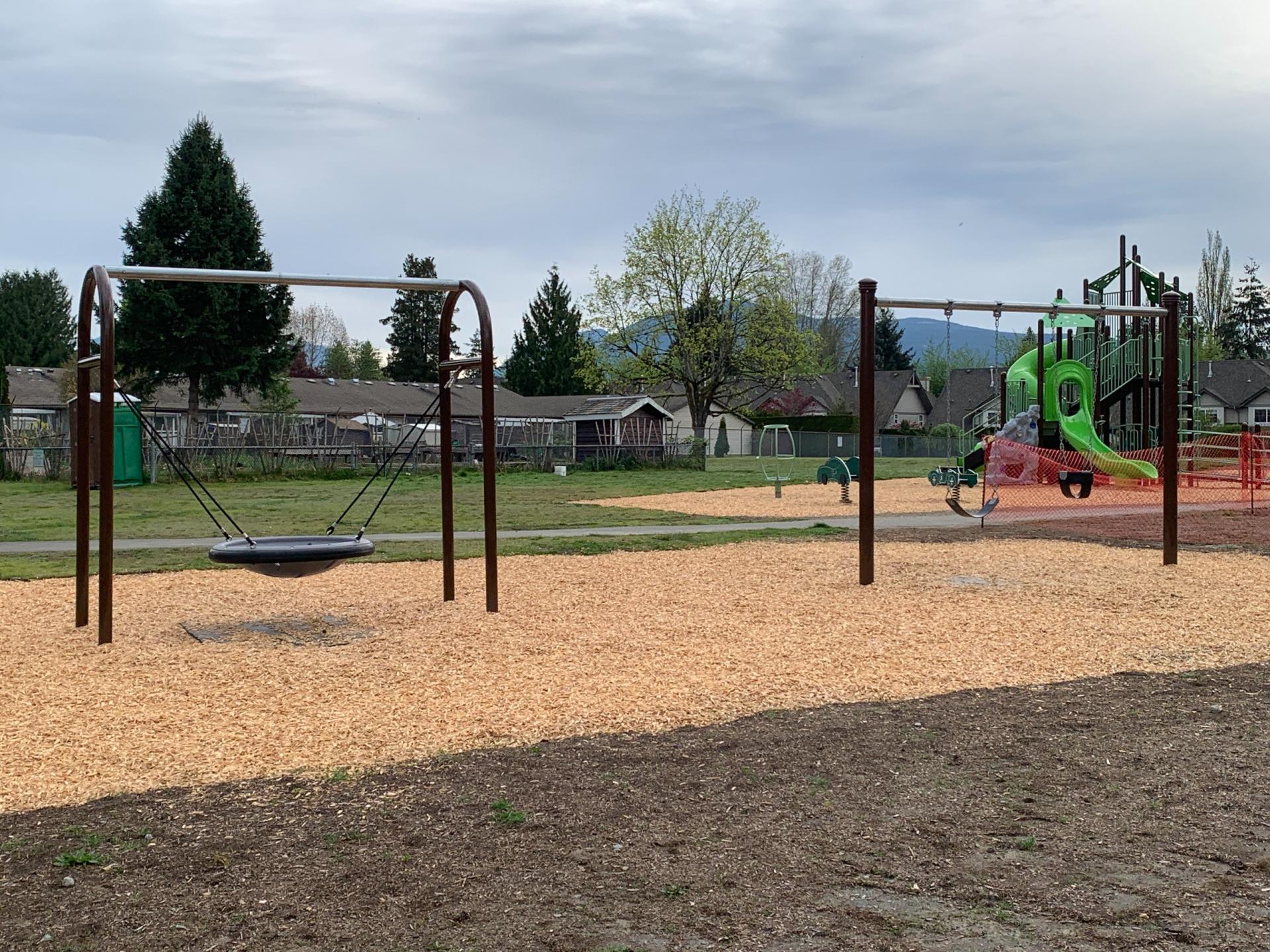 disk swing, belt and bucket swing, playground structure, wood chip paths