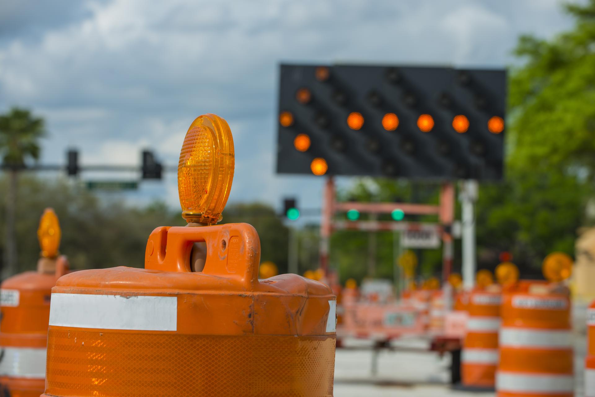 Traffic pylons and an arrow sign in a construction zone