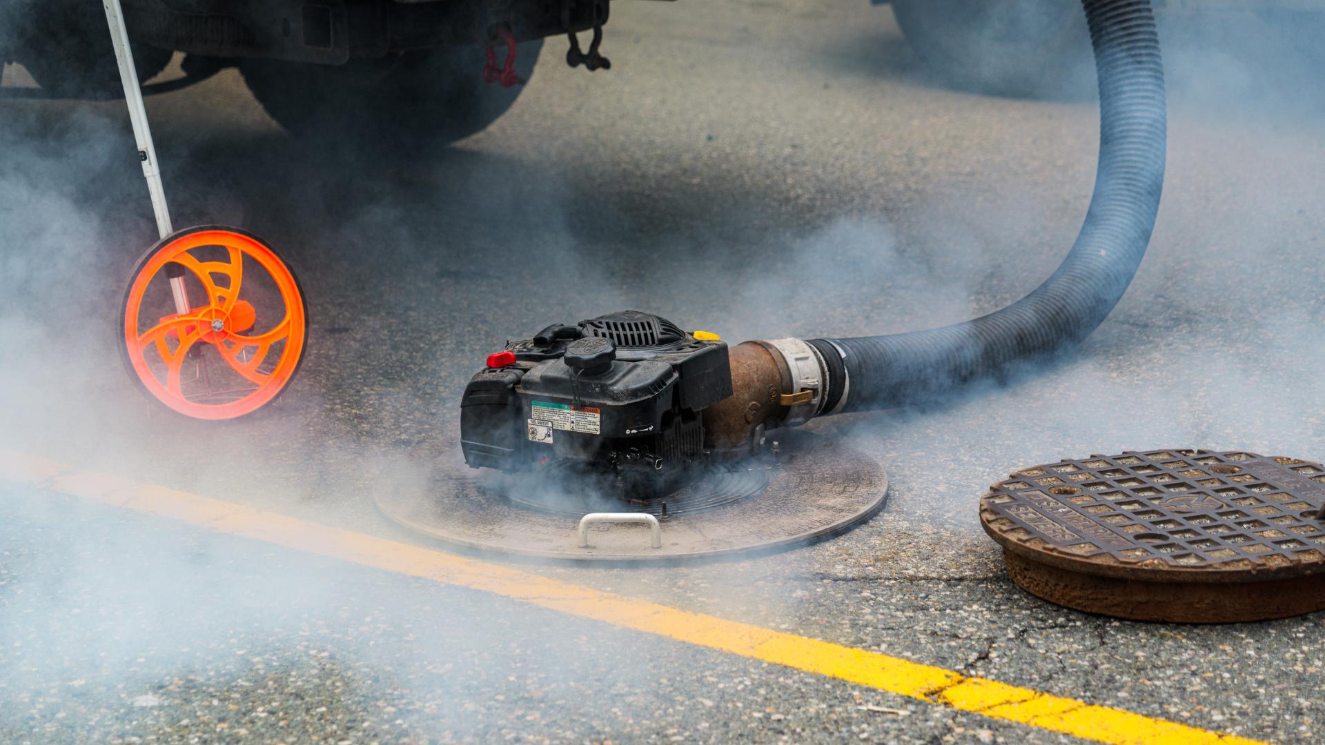 Fog around a maintenance hole during fog testing