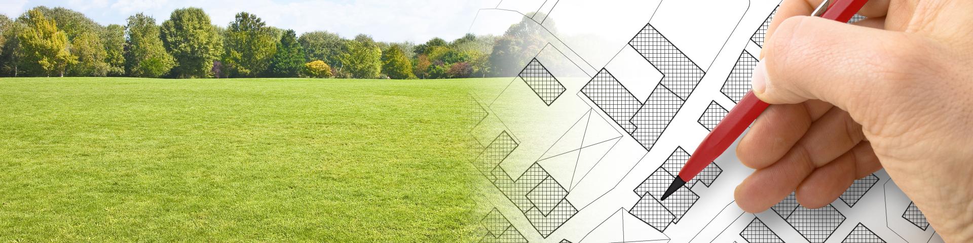 A grassy field fades into a set of housing plans, with someone holding a red pen above them.